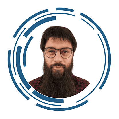 A headshot of Stuart Carter, he is wearing glasses and has a beard